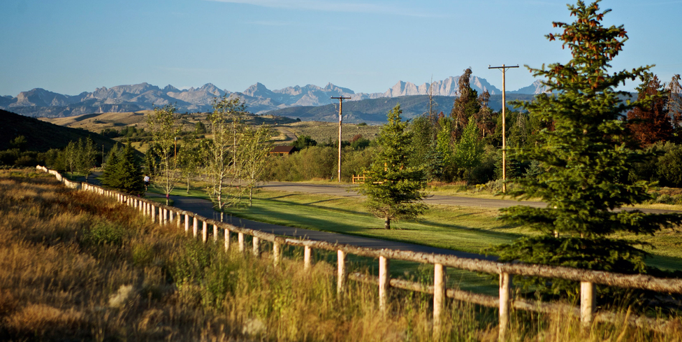 Wind River Mountains panorama with fence-lined road near Split Diamond Meadows